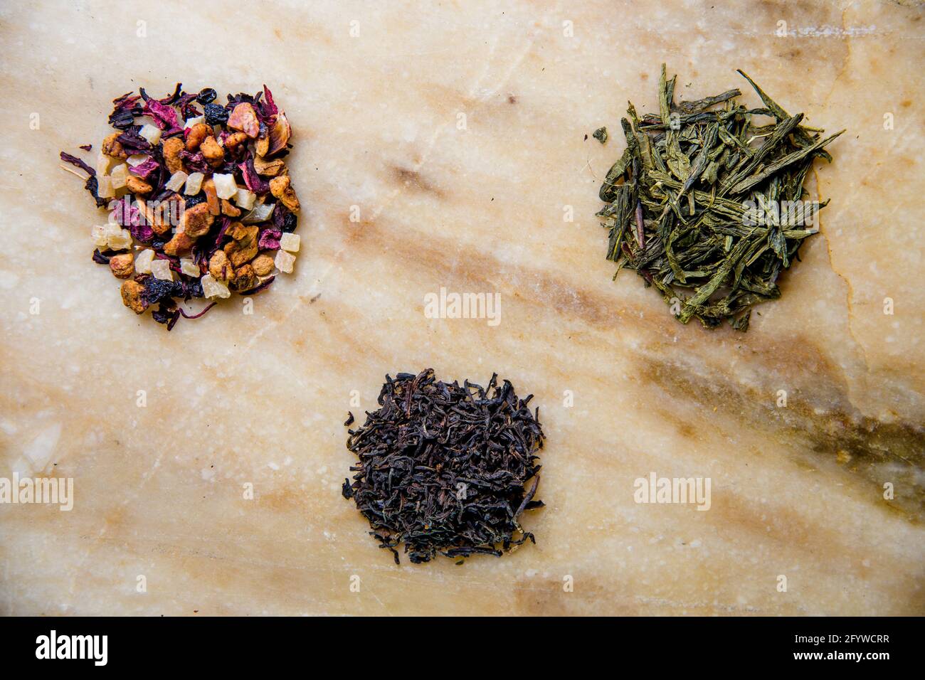 assorted leafy green, fruit and black tea Stock Photo