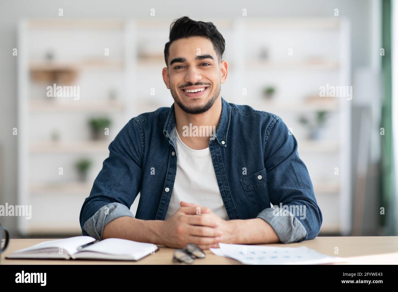 Cheerful arab man sitting hi-res stock photography and images - Alamy