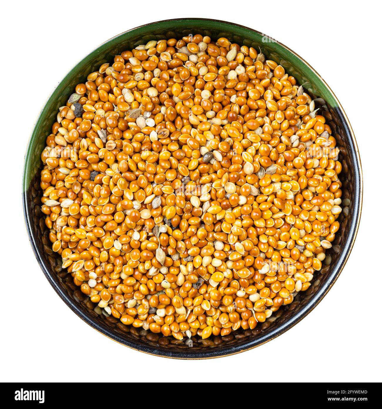 top view of unhulled proso millet grains in round bowl isolated on white background Stock Photo