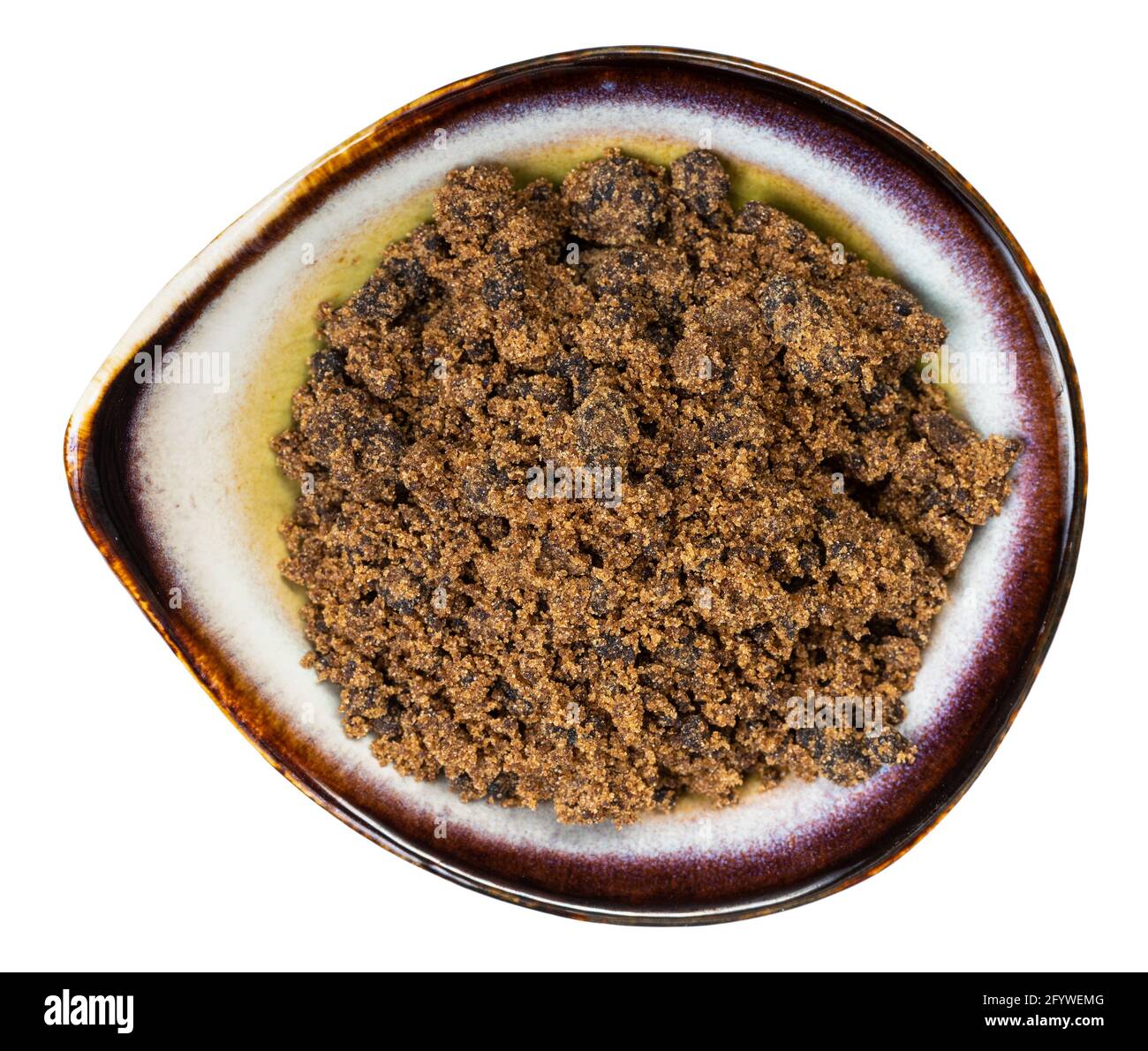 top view of muscovado dark brown cane sugar in ceramic bowl isolated on white background Stock Photo