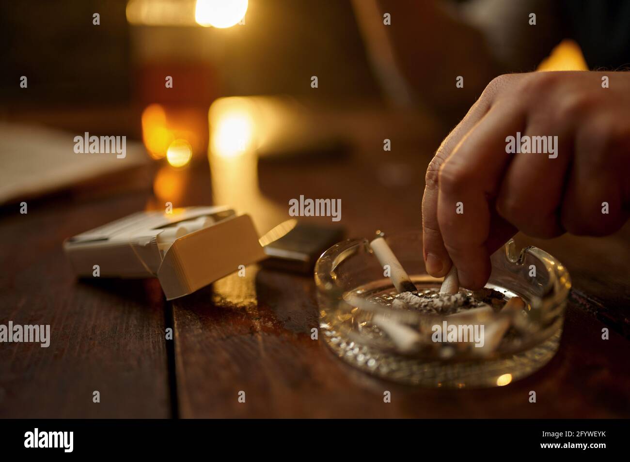 Man puts out a cigarette in ashtray, closeup view Stock Photo Alamy