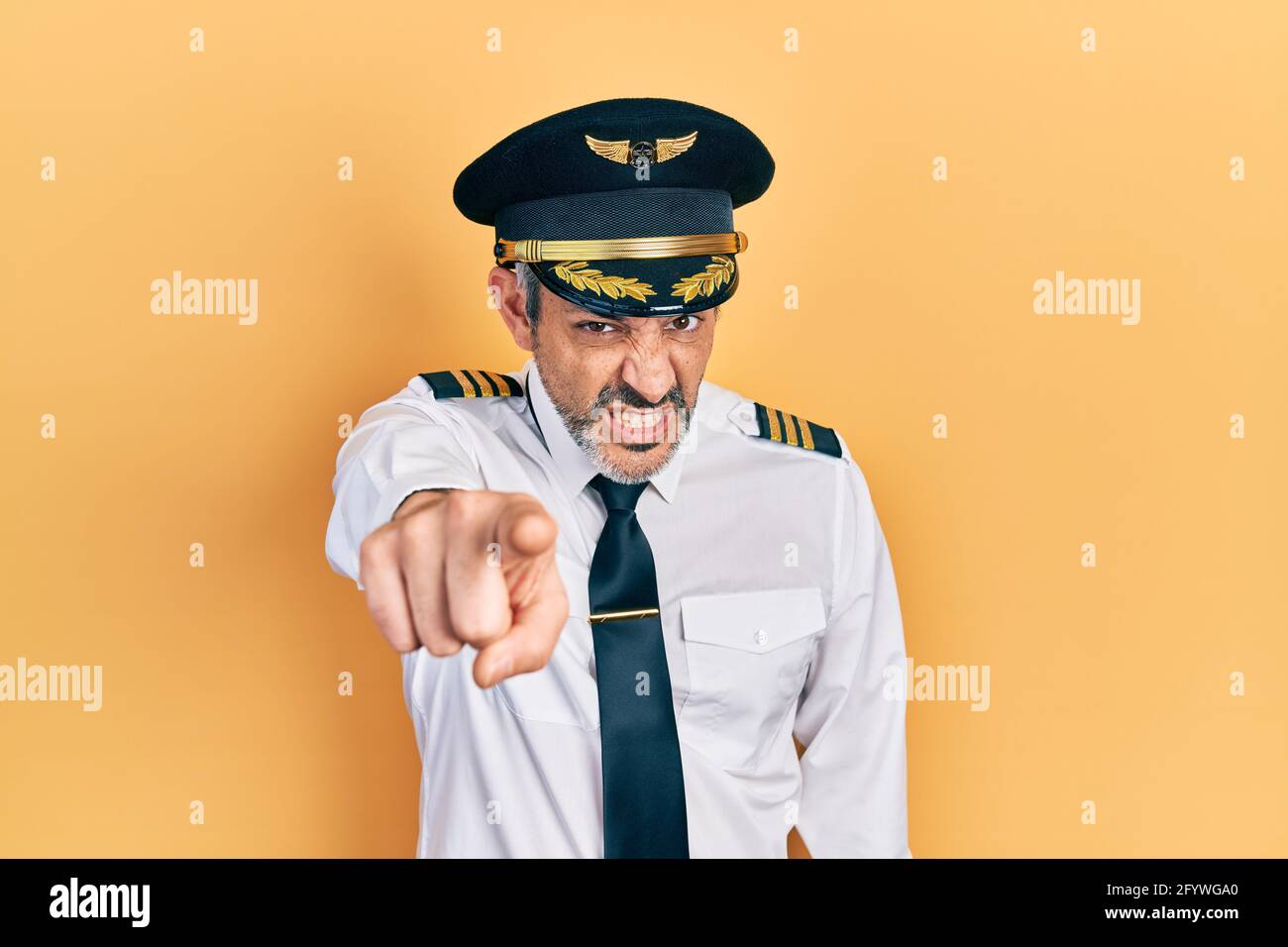 Handsome middle age man with grey hair wearing airplane pilot uniform ...