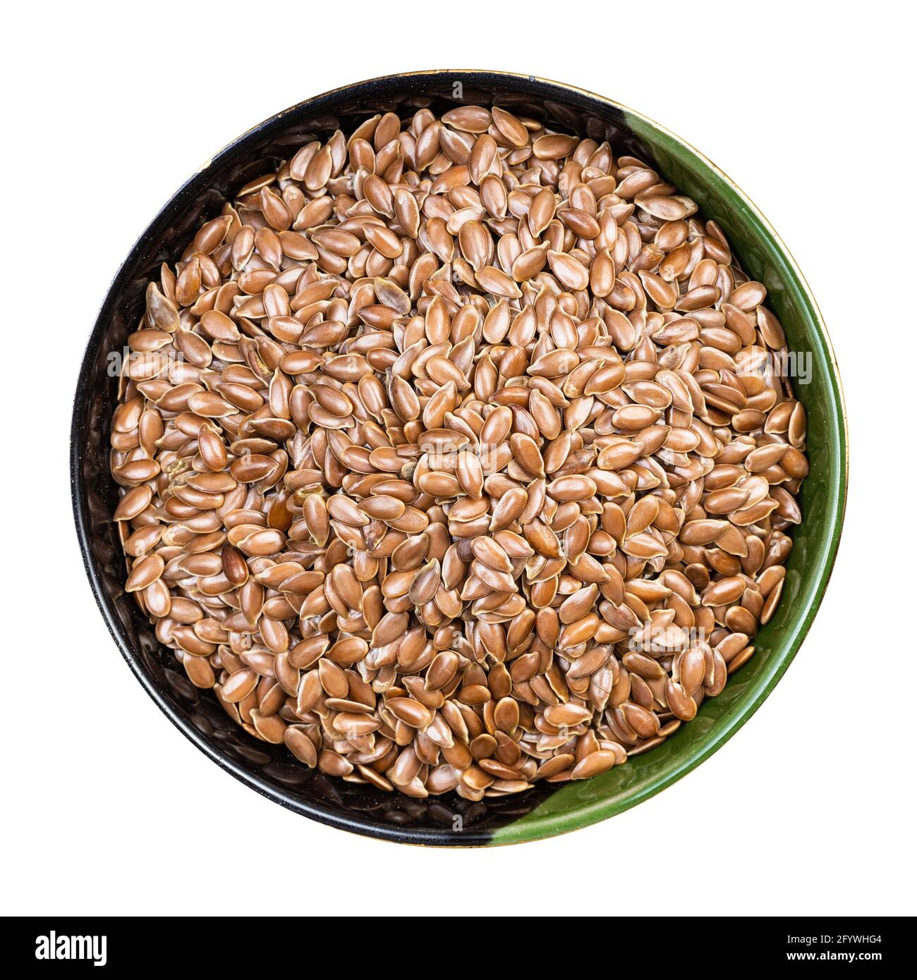 top view of brown flax seeds in round bowl isolated on white background Stock Photo