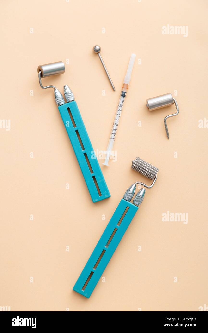 Cosmetology dermaroller dermatology tools, mesoscooter for hardware cosmetology, syringe for youth health injections in face body. Cosmetologists Stock Photo