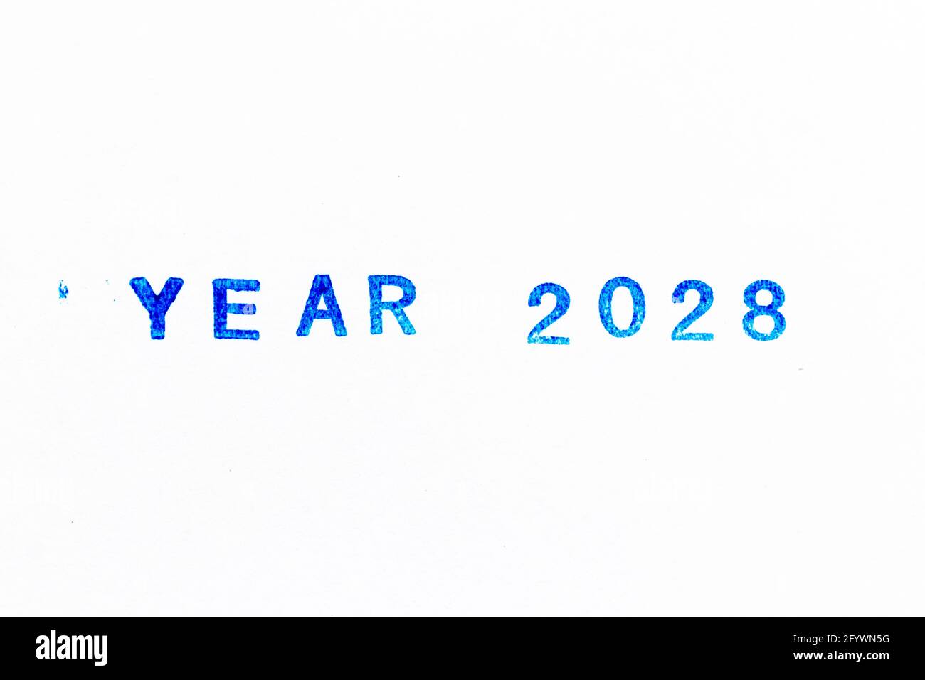 Blue color ink of rubber stamp in word year 2028 on white paper background Stock Photo