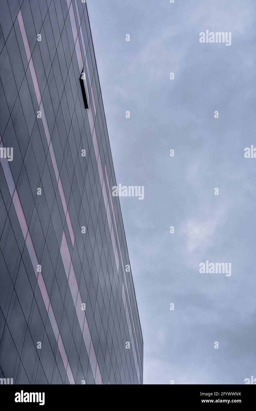An open window on the black granite facade of the Royal danish library in the red morning sunshine, Copenhagen, May 26, 2021 Stock Photo