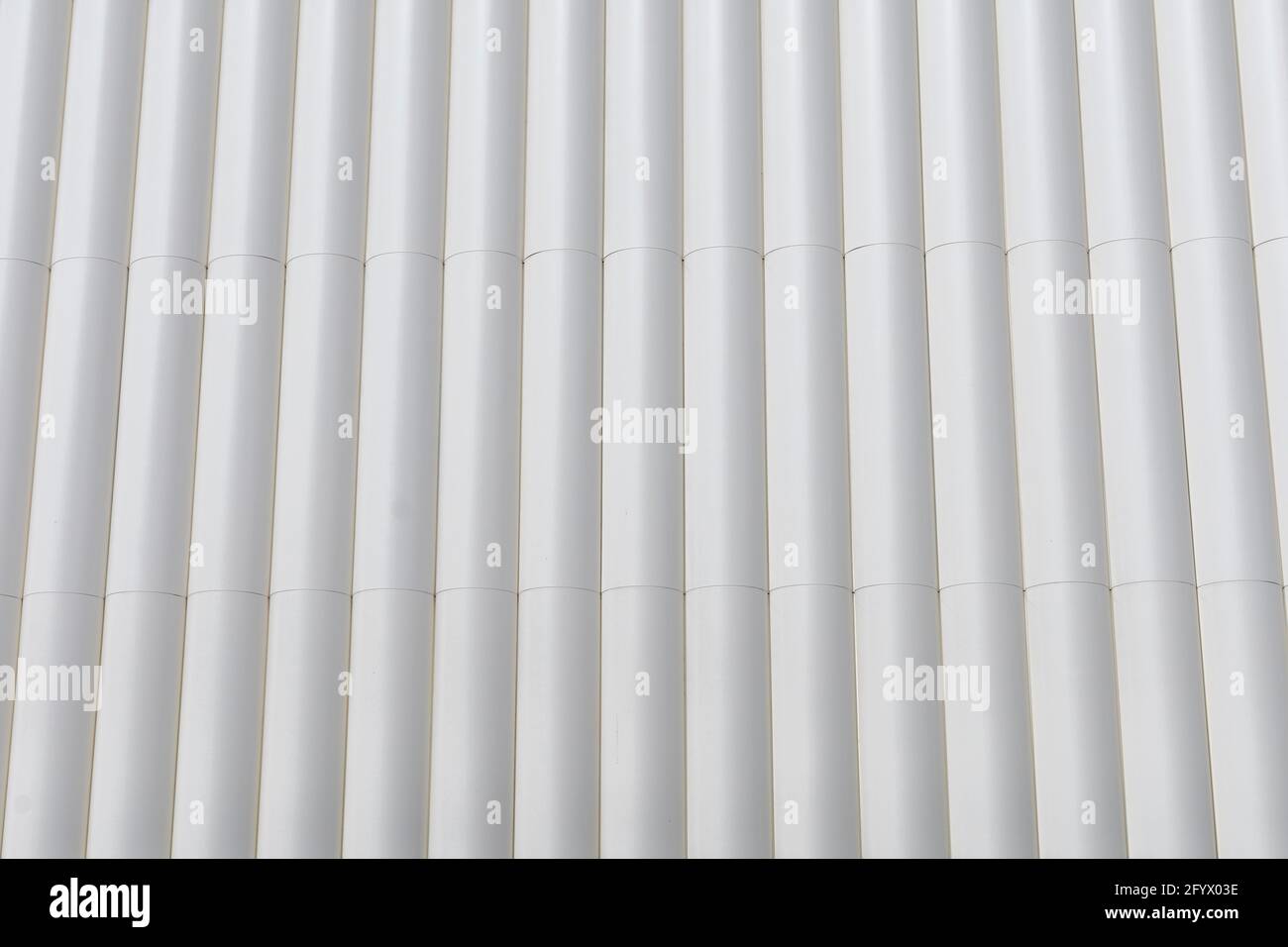 circular metal structure made of several white tubes as a cladding for an outer wall of an external wall construction background concept Stock Photo
