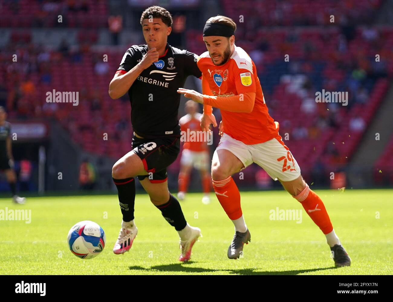 Lincoln City's Brennan Johnson (left) and Blackpool's Luke Garbutt battle for the ball during the Sky Bet League One playoff final match held at Wembley Stadium, London. Picture date: Sunday May 30, 2021. Stock Photo