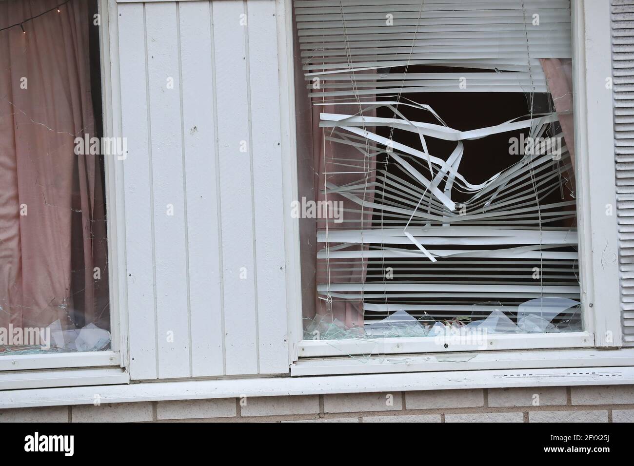 Broken window at an apartment building at a crime scene, in the city of