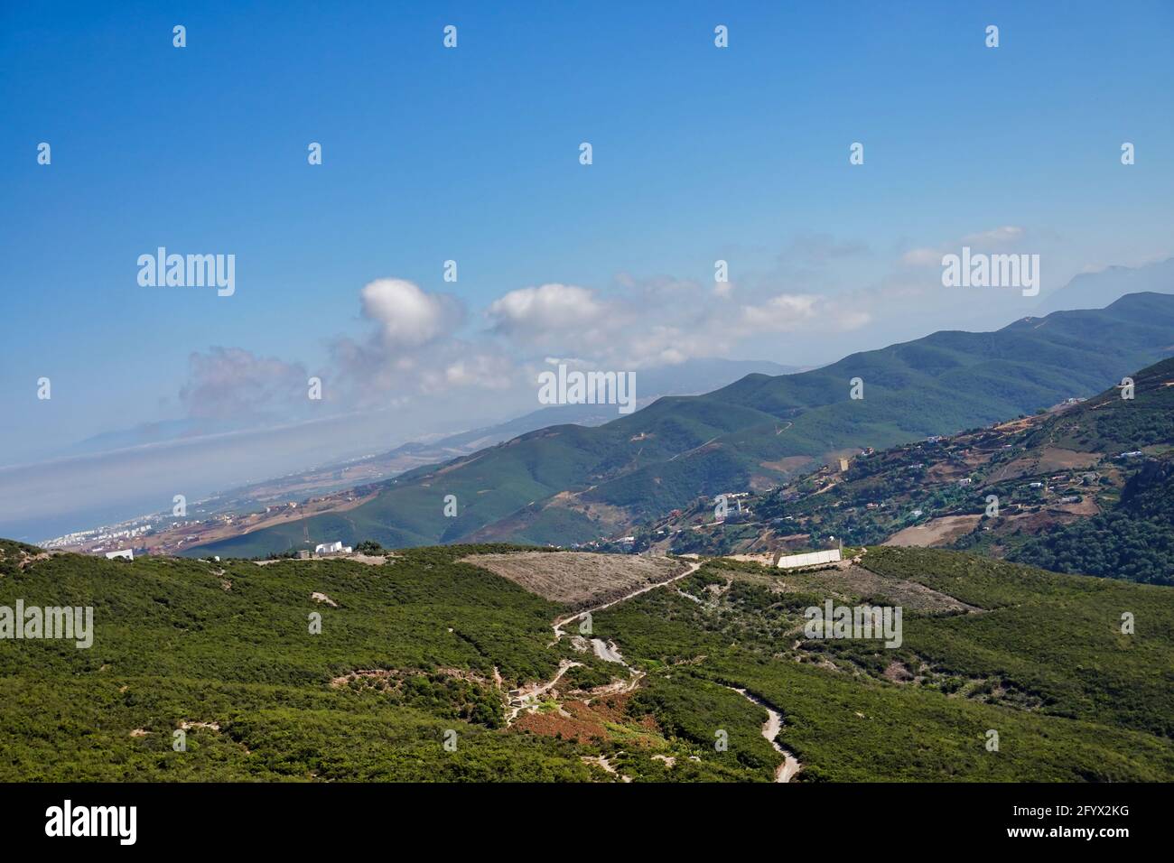 an aerial view of beautiful, green mountain forests under the cloudy ...