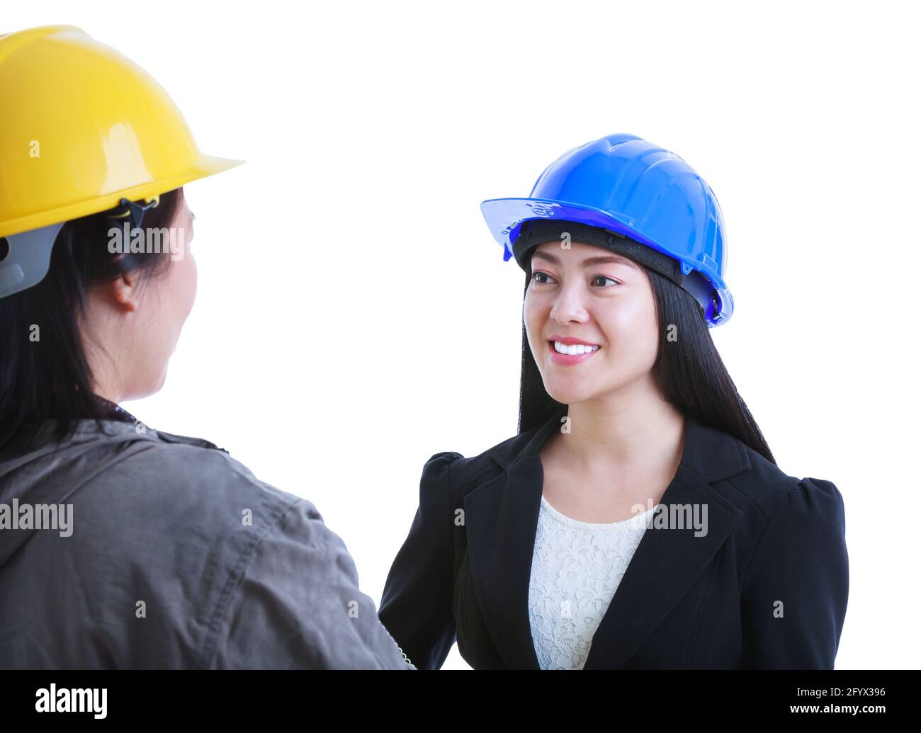 Asian engineer talking with construction worker. Beautiful and confident young female architect wearing a blue helmet and smiling. Isolated on white b Stock Photo