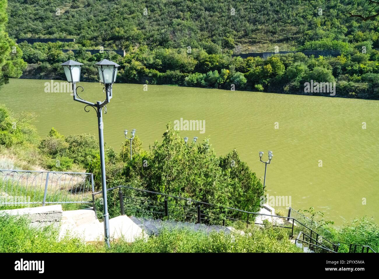 Lamp post on the background of green water Stock Photo