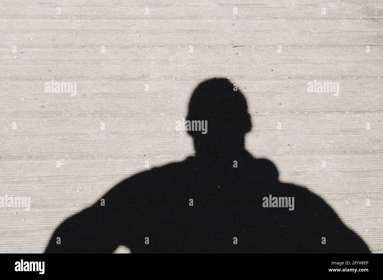 Shadow of a man on the concrete background of the street Stock Photo