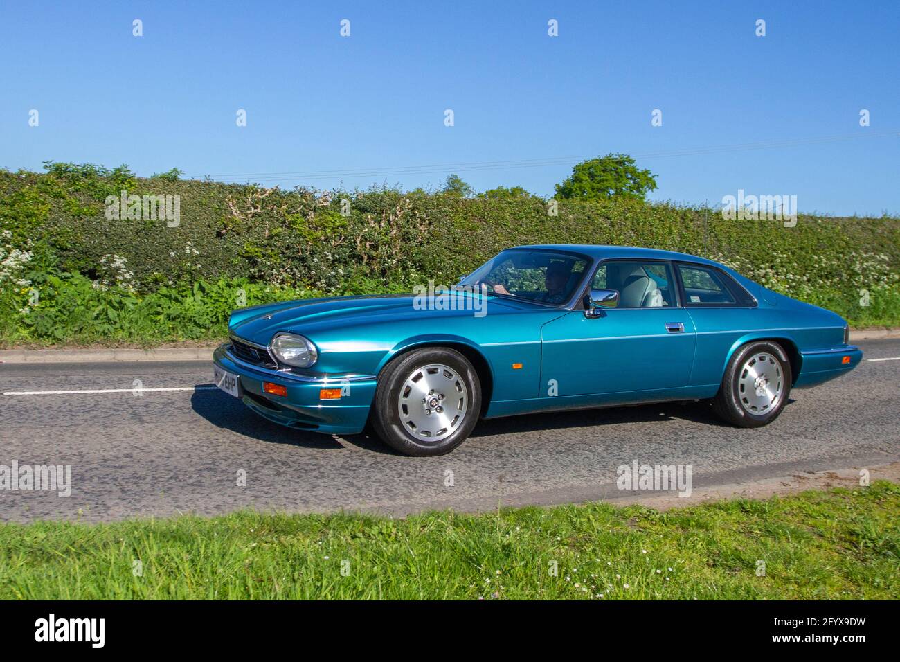2012 Jaguar Xj-S 4.0 auto, Vehicular traffic, moving vehicles, cars, vehicle driving on UK roads, motors, motoring  en-route to Capesthorne Hall classic May car show, Cheshire, UK Stock Photo