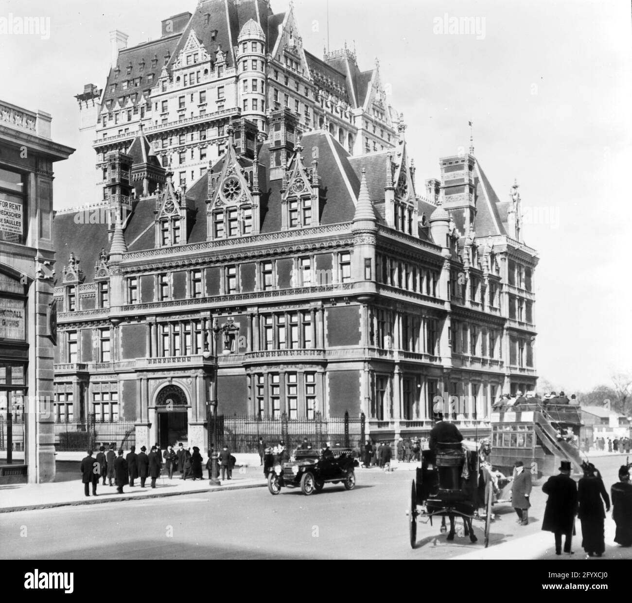 Exterior view, looking north across the intersection of 5th Avenue and 57th Street, of the Cornelius Vanderbilt II House, New York, New York, May 1910. The home, built in 1883 was the largest private home in Manhattan. Visible above it is the Plaza Hotel. (Photo by Burton Holmes) Stock Photo