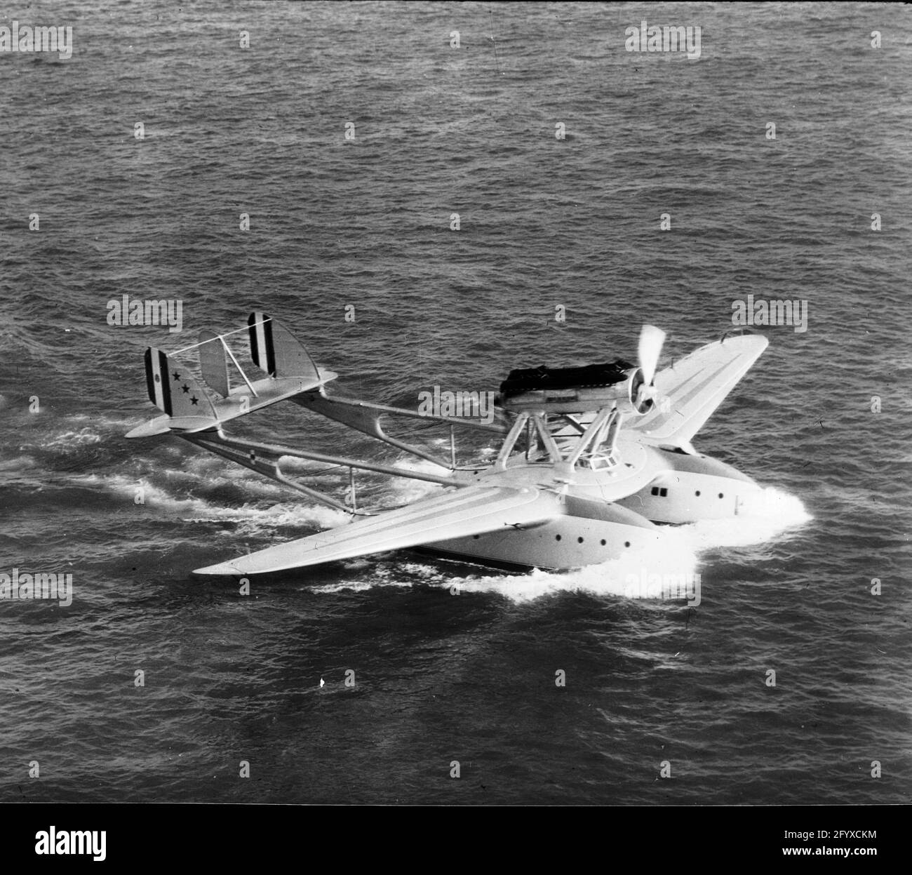 An amphibious aircraft on water. (Photo by Burton Holmes Stock Photo