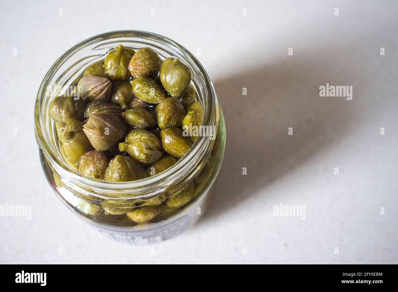 Glass jar of spanish pickle capers. Closeup Stock Photo Alamy