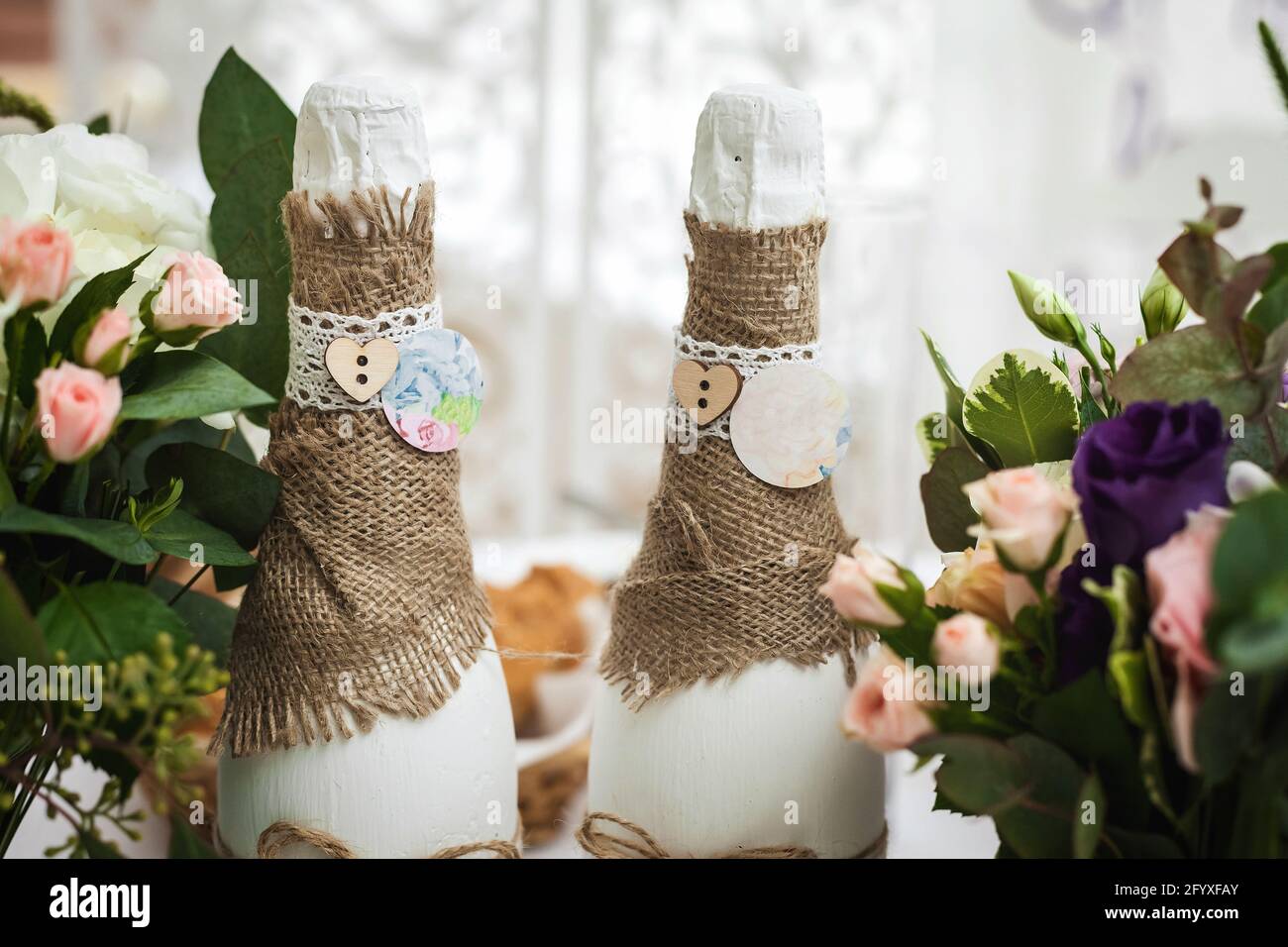 decorated champagne bottles and flowers. wedding theme Stock Photo Alamy