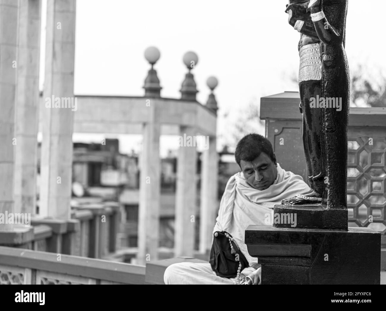 indian hindu devotee pray in front of a idol at iskon temple delhi. Stock Photo