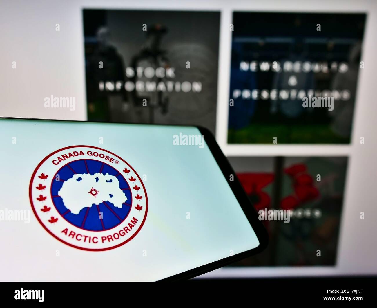 Mobile phone with logo of winter clothing company Canada Goose Holdings Inc.  on screen in front of web page. Focus on center-right of phone display  Stock Photo - Alamy