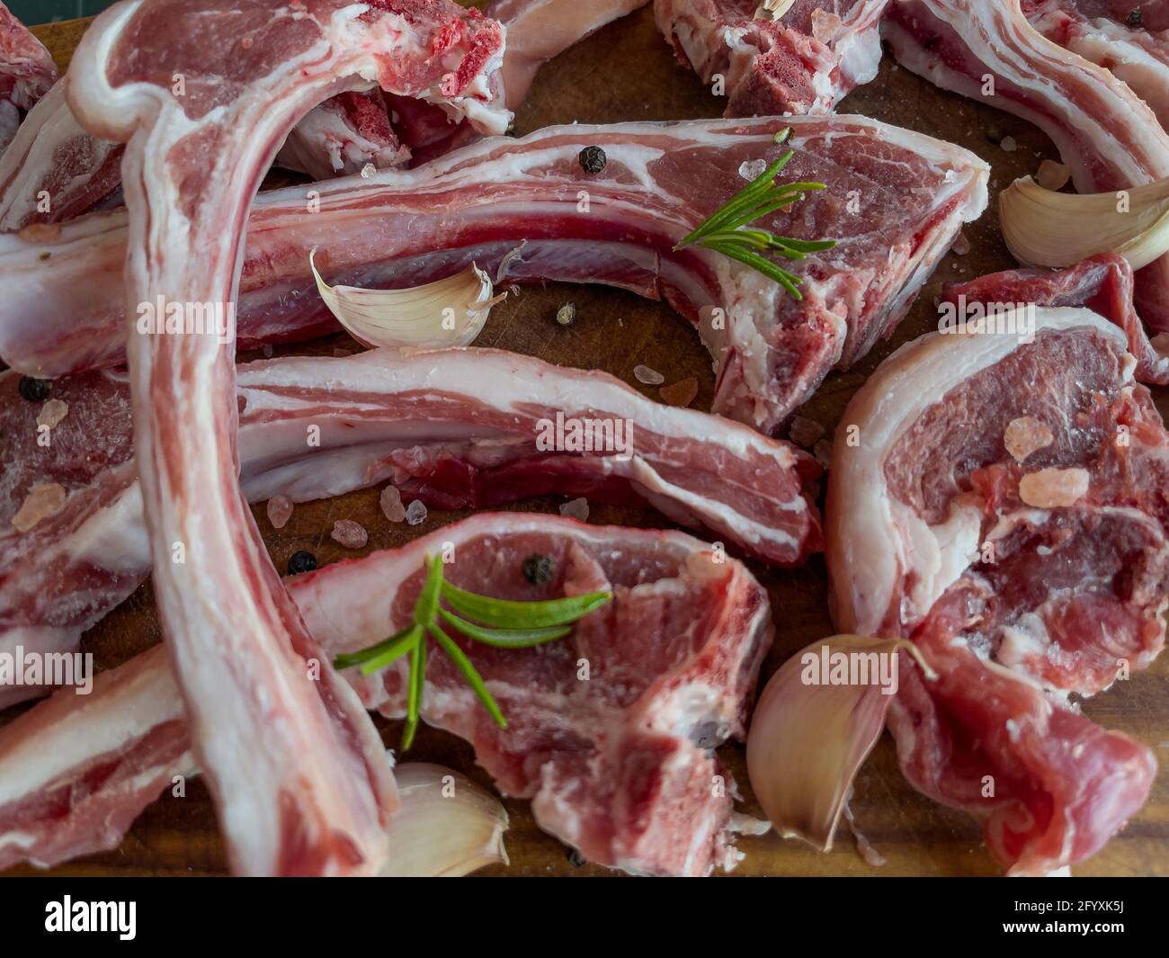 Raw lamb ribs with rosemary, garlic, salt and black pepper ready to be  grilled Stock Photo - Alamy