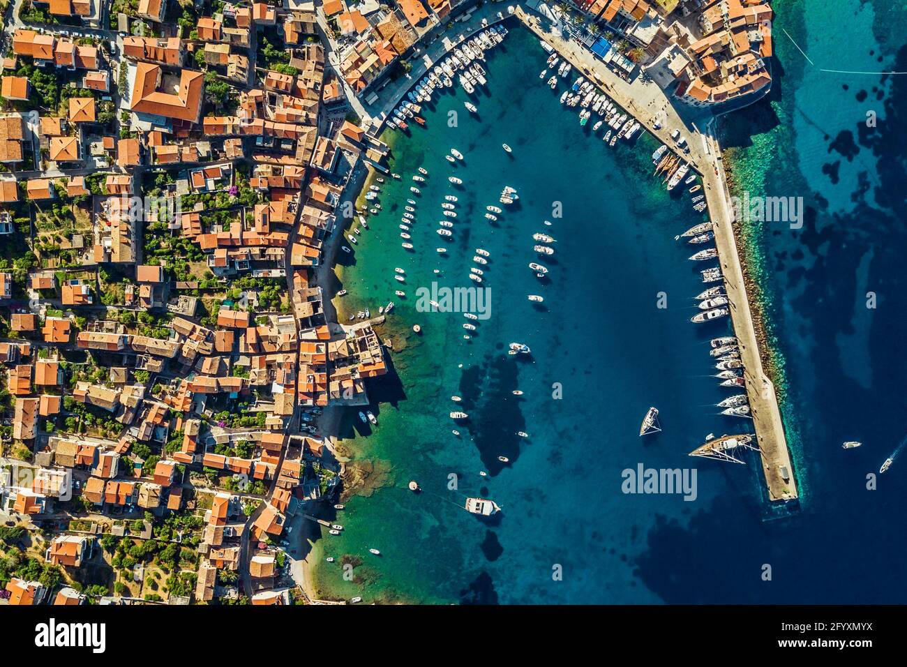 Drone View on a Beach Bay. Aerial View of a Coastal City with Red Roofs near Yacht Harbor. Luxury Summer Vacation in Dubrovnik. Croatia. Stock Photo