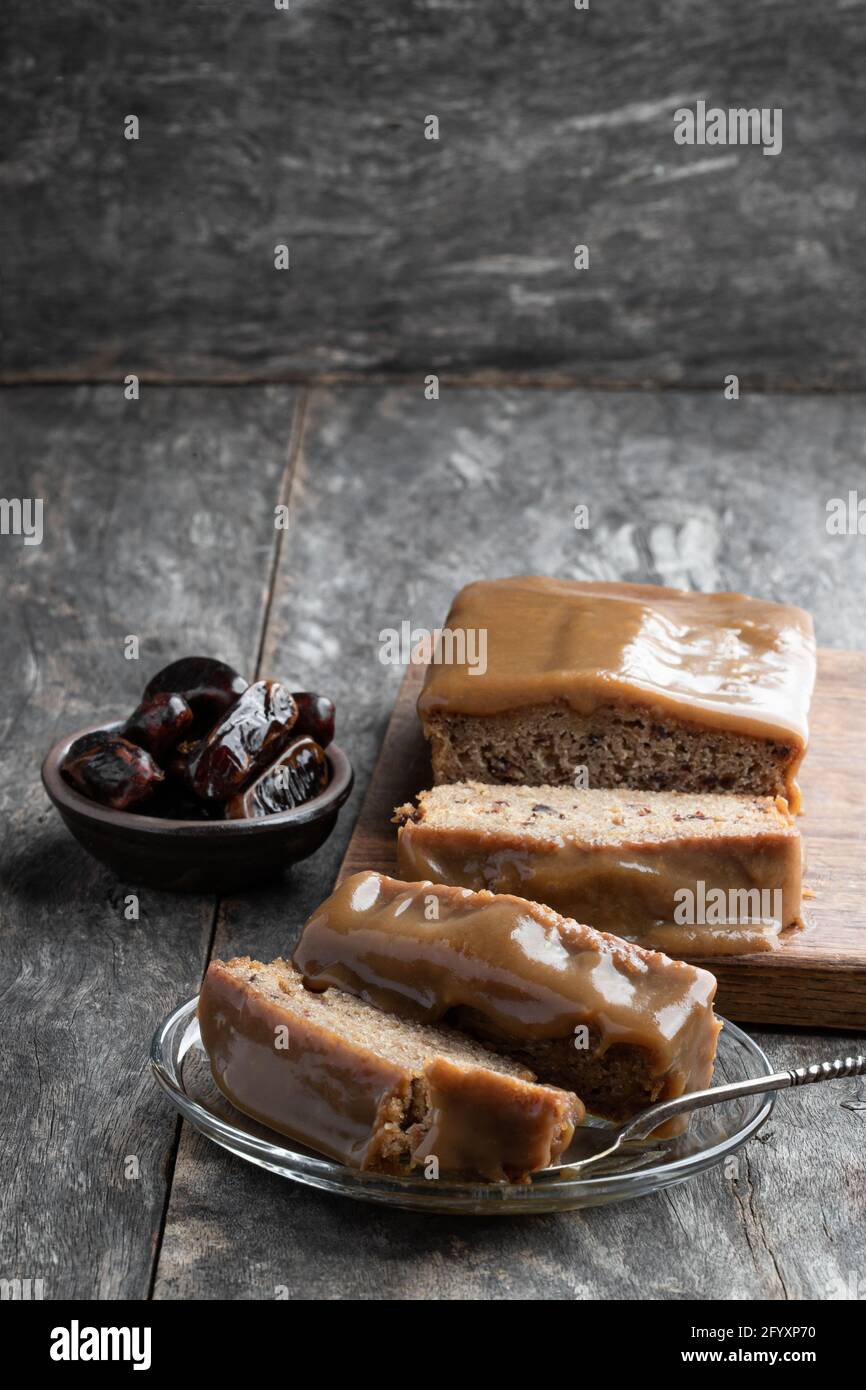 Sticky toffee pudding butter sponge with dates on wooden table Stock