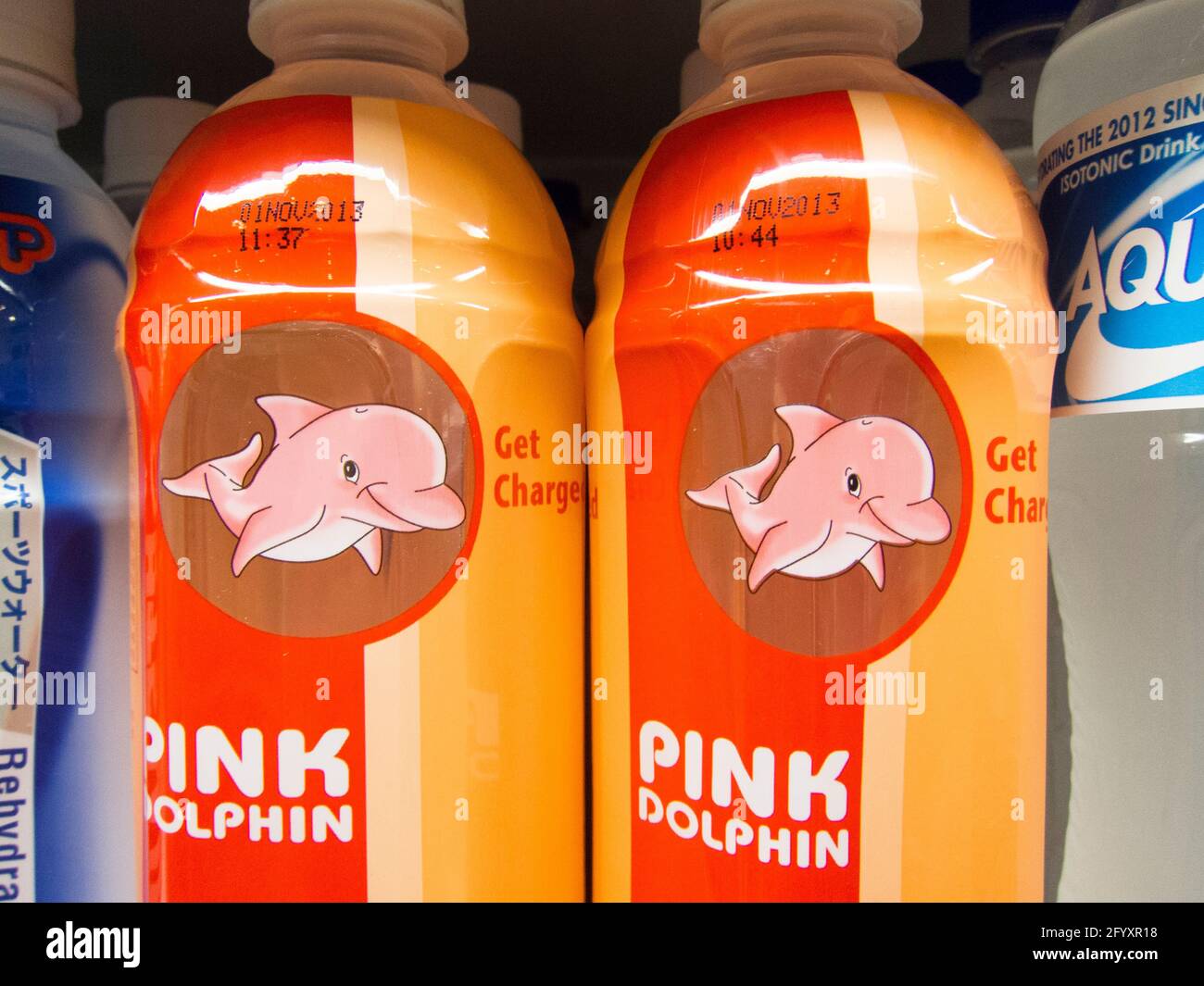 Detail of water bottles of Veo's Pink Dolphin energy drink at a grocery store. In Singapore. Stock Photo