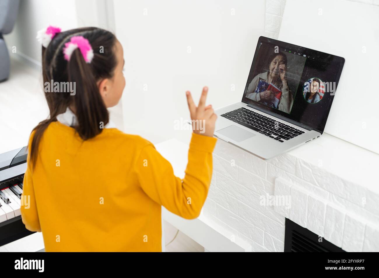 Homeschool little young kid girl learning piano from computer ...