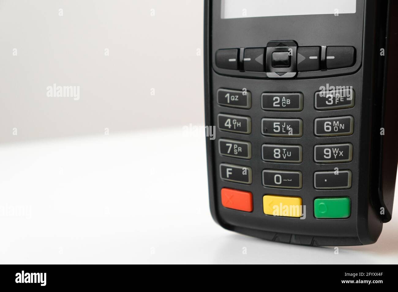 POS terminal or credit card reader machine on the white table with copy space.  Stock Photo