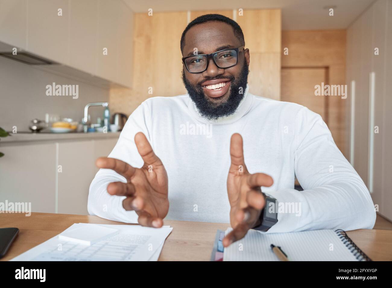 Portrait of talking young african amercian man having online video chat Stock Photo