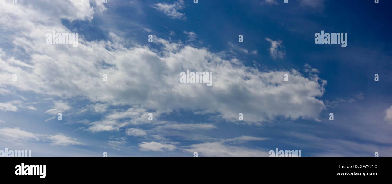 Landscape of blue sky with blurred clouds floating brightly across the sky on a clear sunny day Stock Photo
