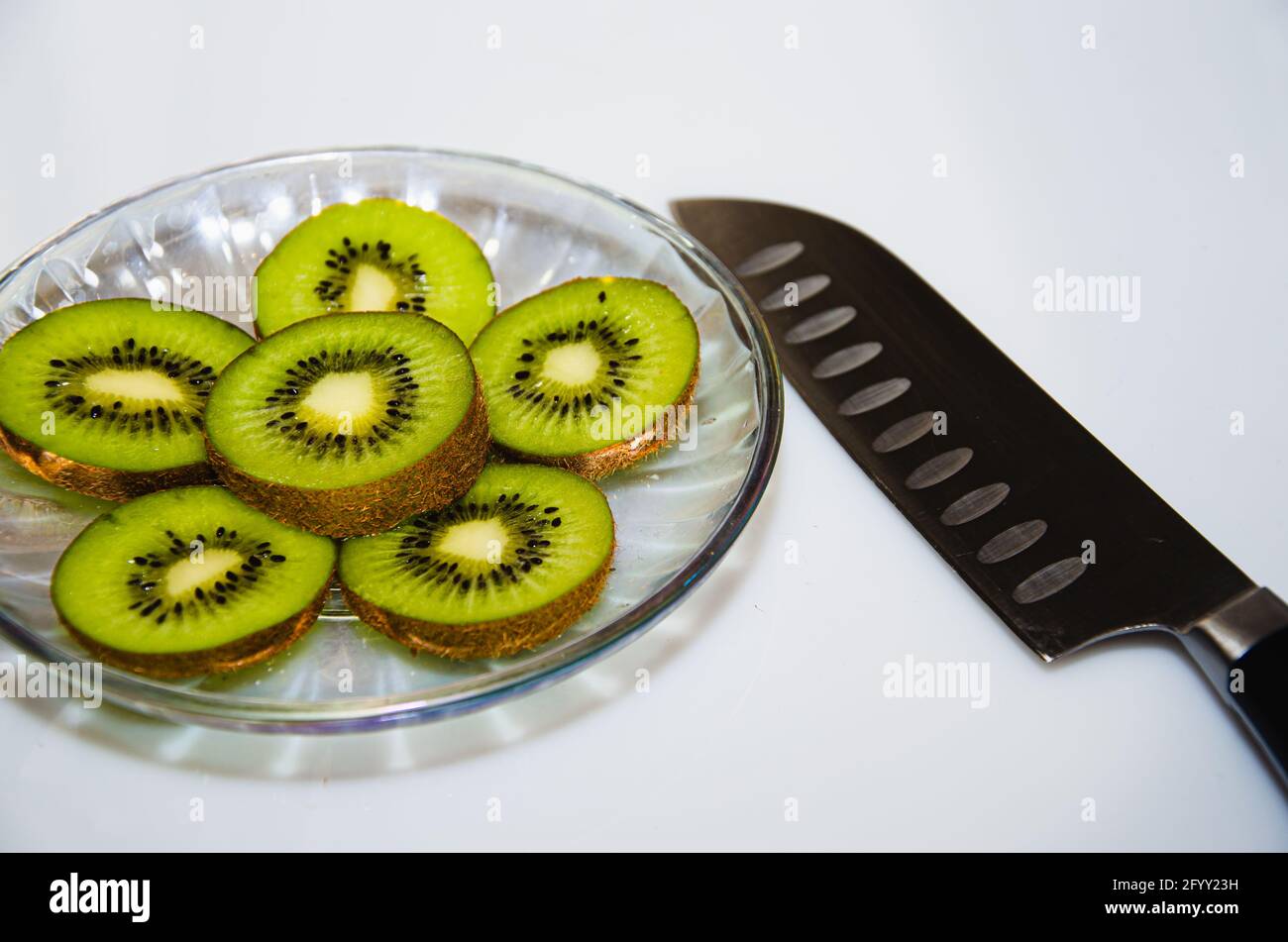 Kiwi fruit cut into pieces cook white Stock Photo Alamy