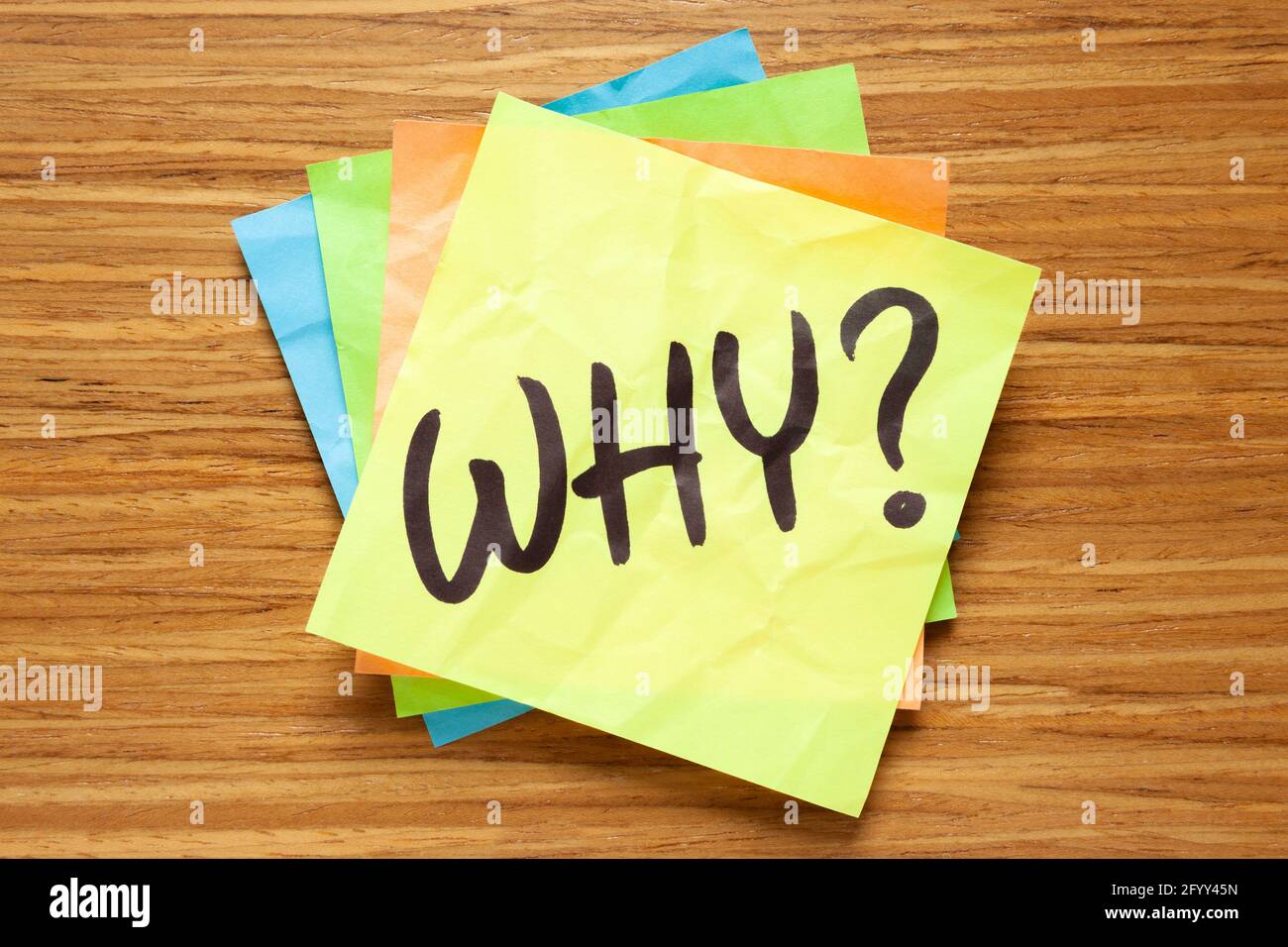 Existential question Why handwritten on a sticky note. Philosophical concept about the purpose of life. Stock Photo