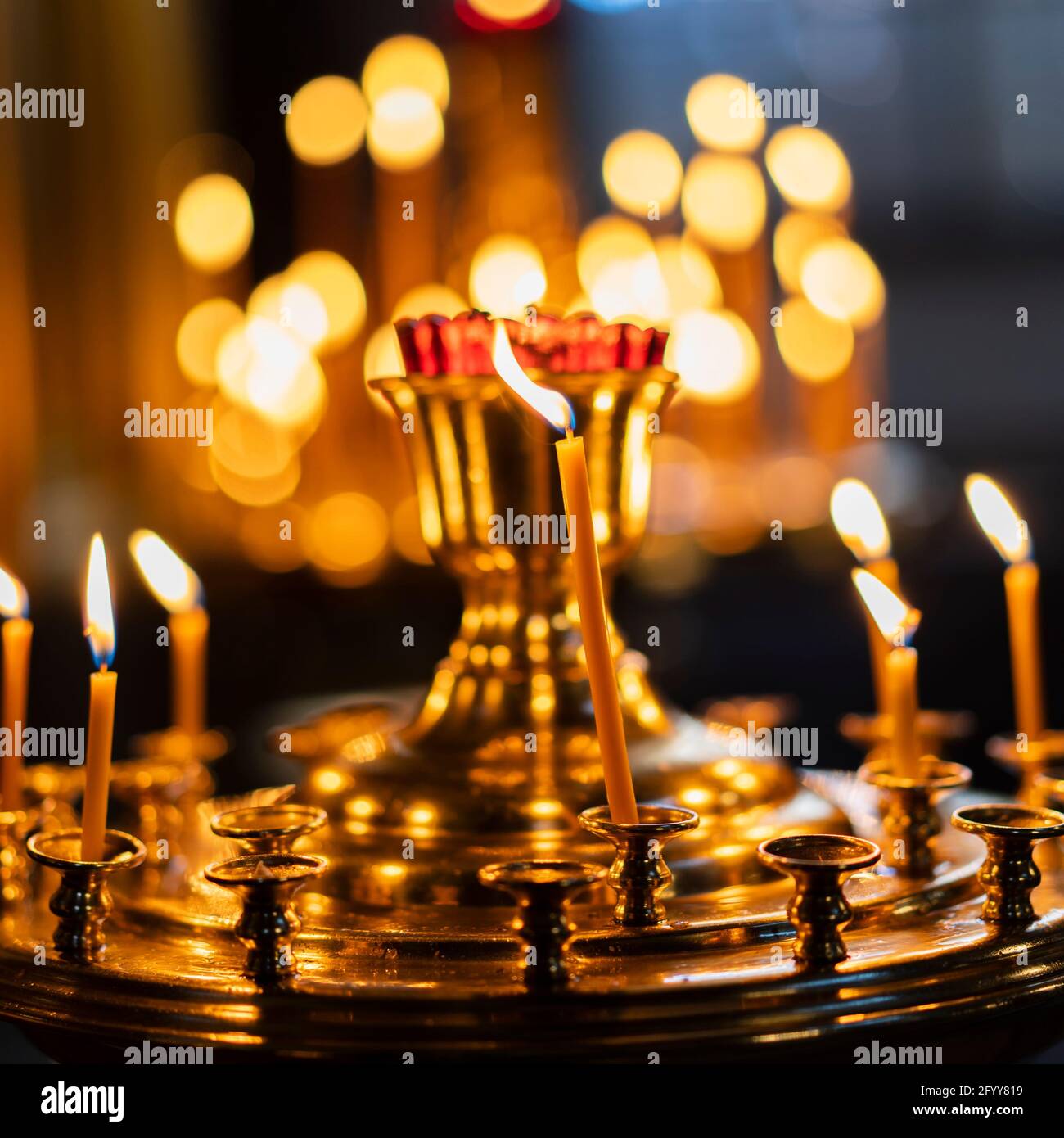 Church candles. Burning candles on a candlestick in an Orthodox church