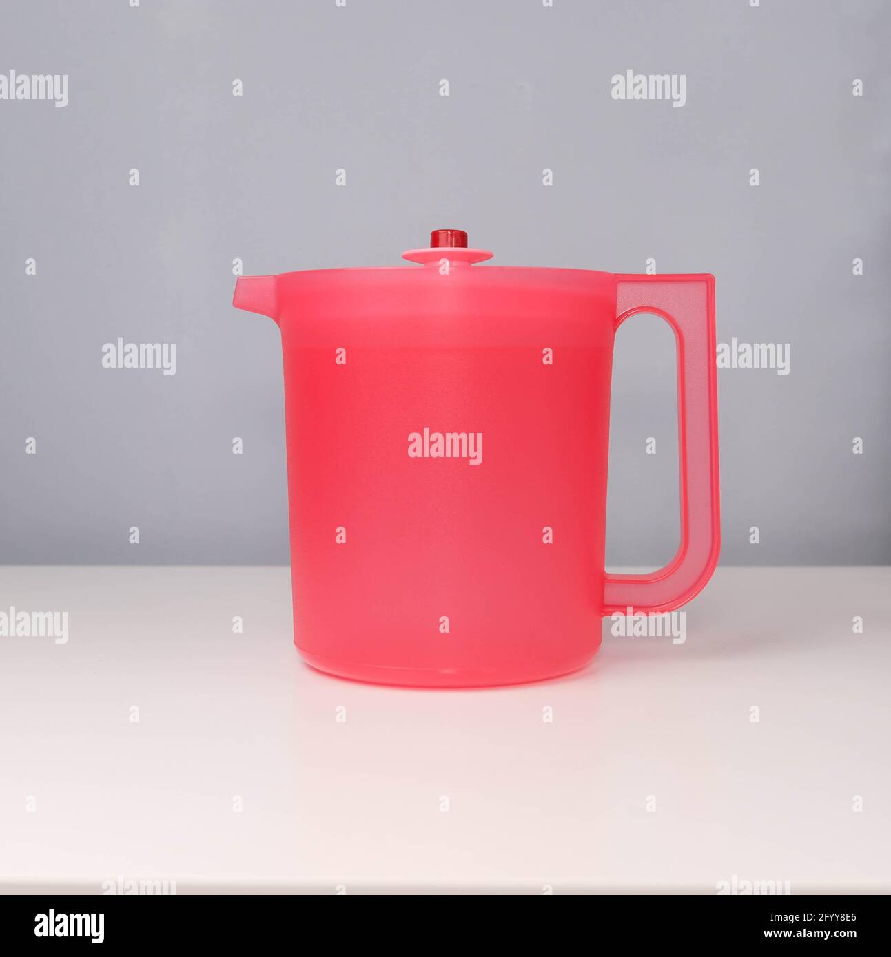 Red water jug isolated on a grey and white background Stock Photo Alamy