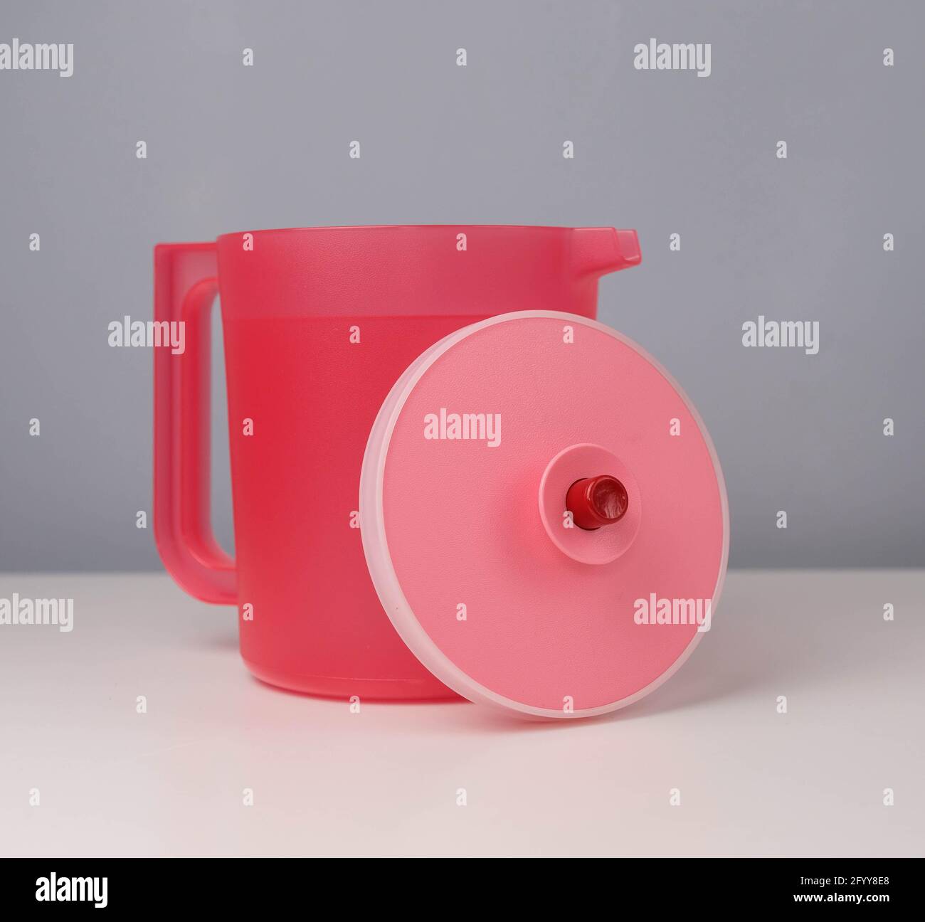 Red water jug isolated on a grey and white background Stock Photo Alamy