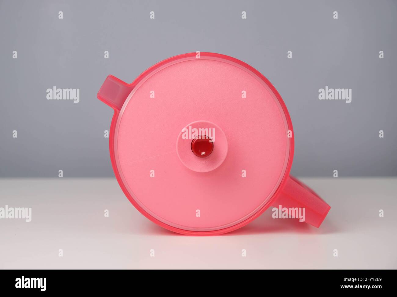 Red water jug isolated on a grey and white background Stock Photo Alamy