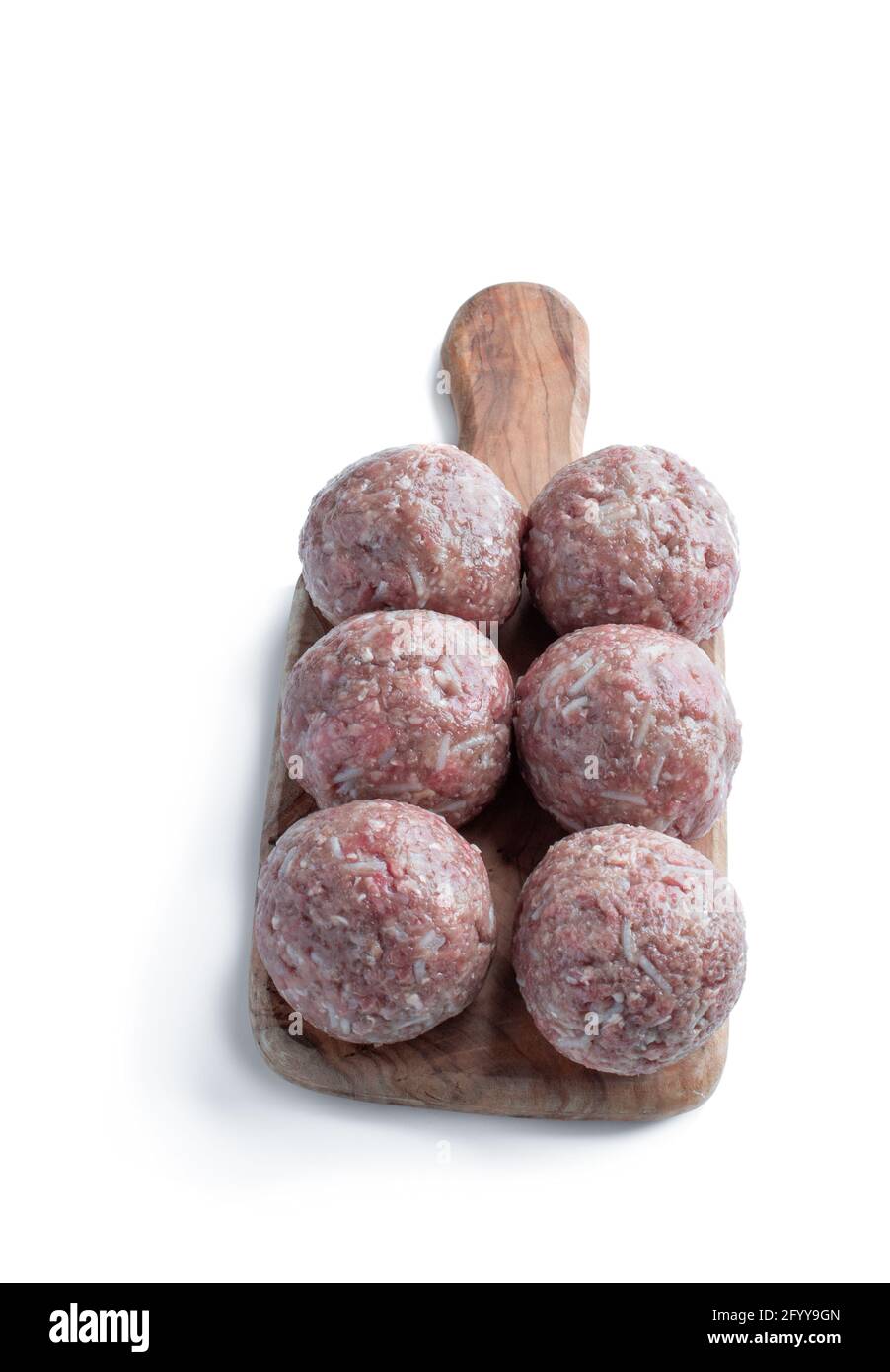 Raw meat  balls on wooden cutting board isolated on white Stock Photo