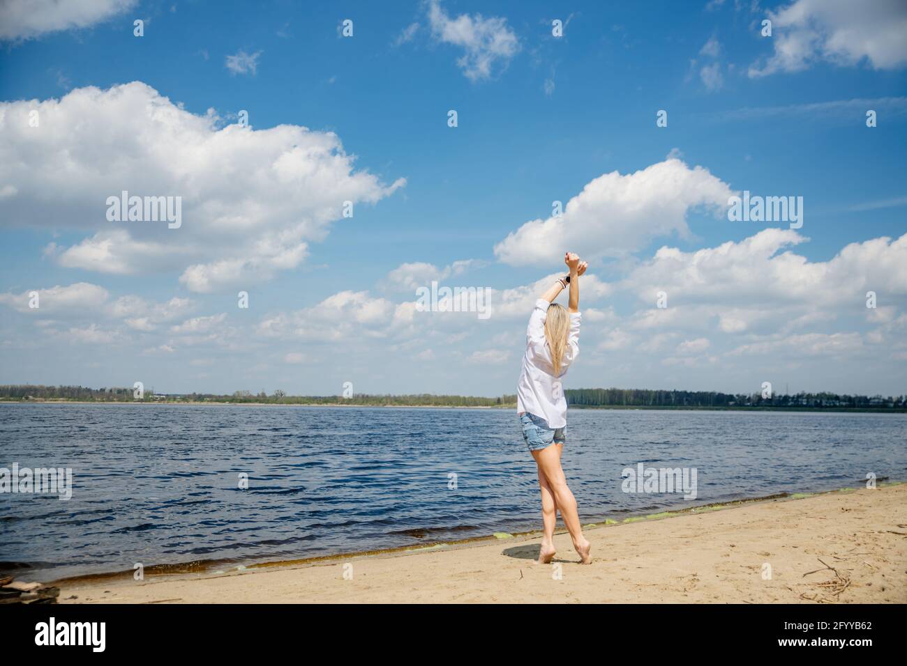 Woman arms raised rear view hi-res stock photography and images - Alamy