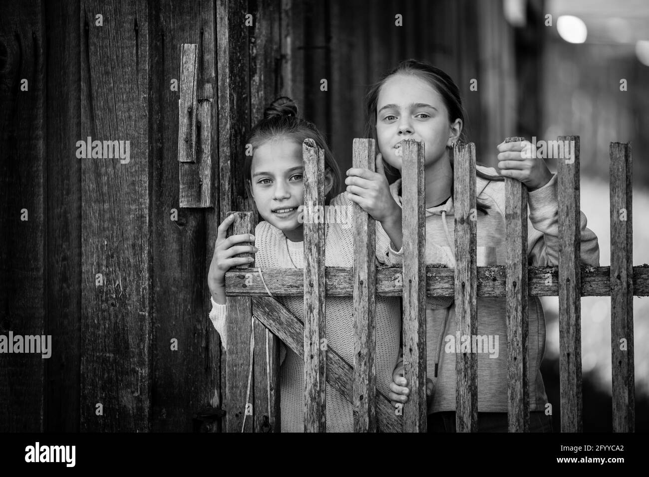 Two girls sisters or girlfriends in the village. Black and white photo. Stock Photo