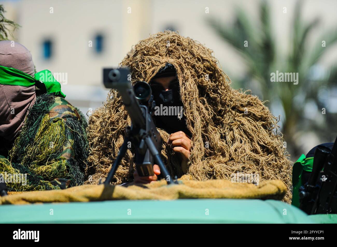 Under the leadership of wanted men of Hamas, Al-Qassam holds a celebration and a military parade to honor the families of the martyrs in northern Gaza Stock Photo