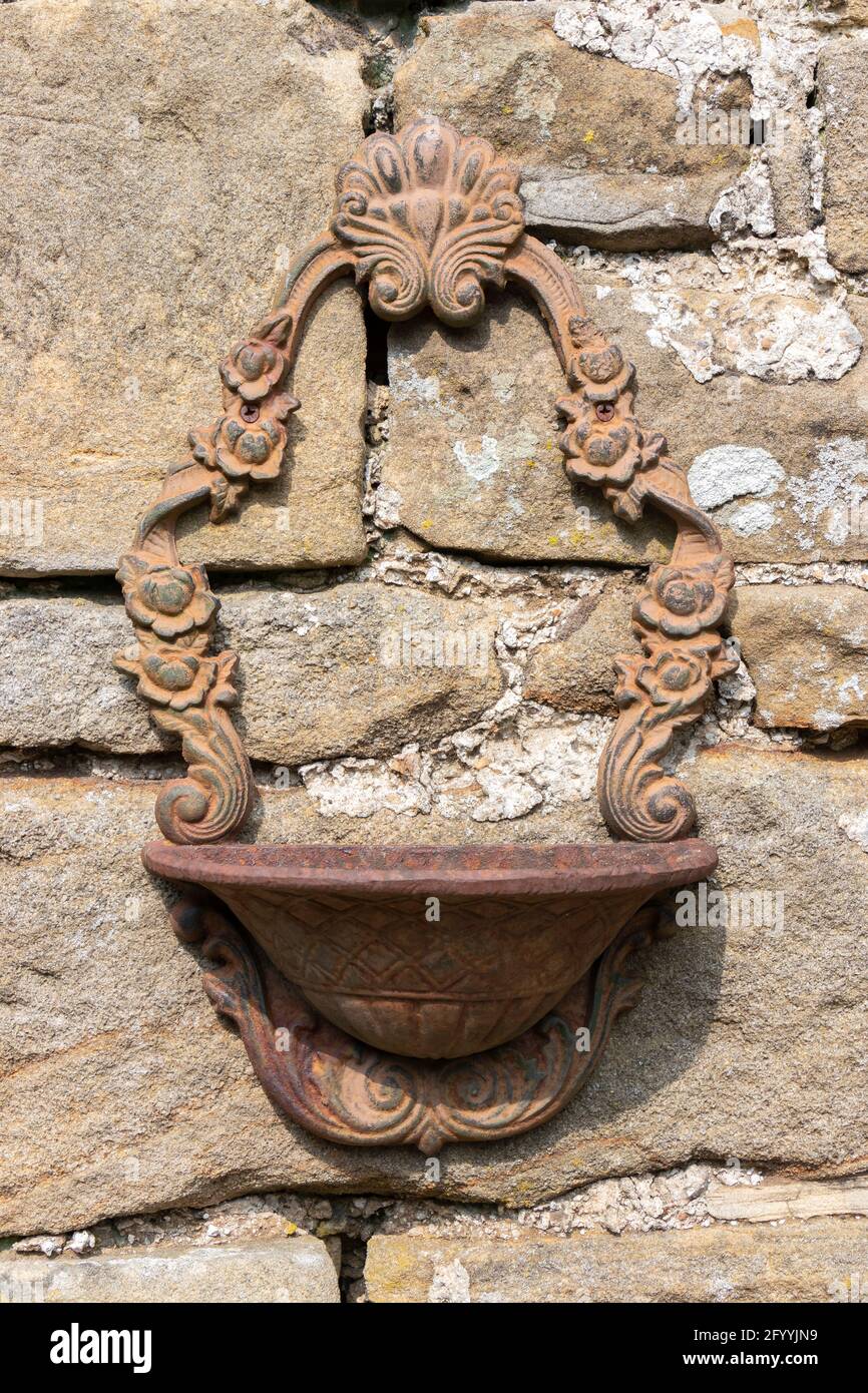 decorative metal bird bath or planter on stone wall at farm in Hadrian's Wall Northumberland Stock Photo
