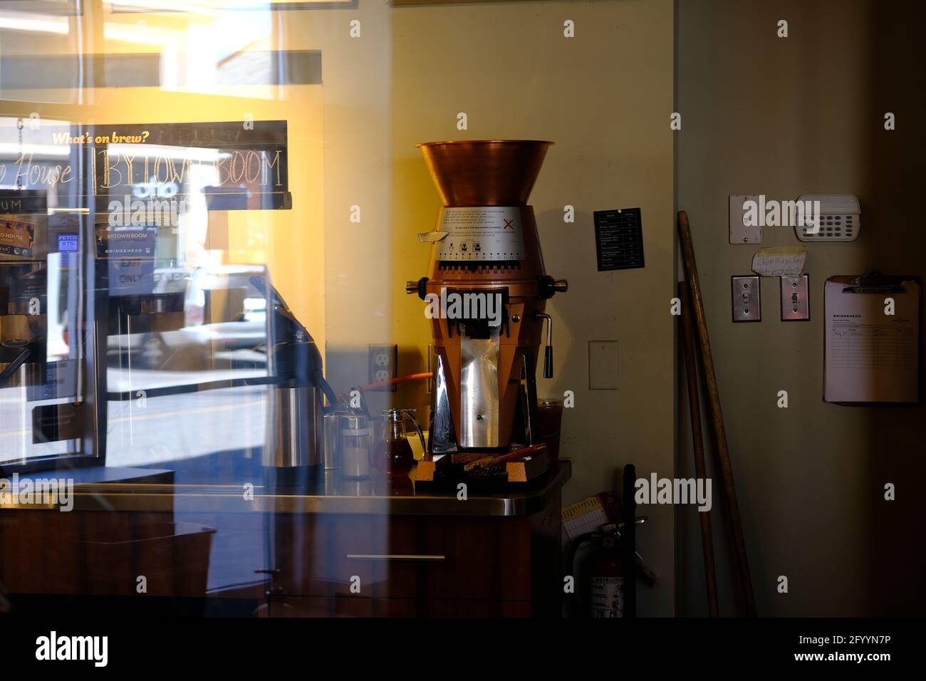 Large copper or brass and steel industrial grinder (coffee) at the local coffee shop in Ottawa, Ontario, Canada. Stock Photo