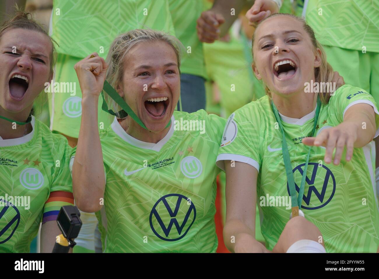Cologne, Germany. 30th May, 2021. Alexandra Popp ( 11 Wolfsburg ), Zsanett Jakabfi ( 3 Wolfsburg ) and Fridolina Rolfö ( 14 Wolfsburg ) celebrate their winning of the DFB Pokal at the ceremony after the DFB Women Cup Final match between Eintracht Frankfurt and VfL Wolfsburg at RheinEnergieSTADION in Cologne, Germany. Credit: SPP Sport Press Photo. /Alamy Live News Stock Photo