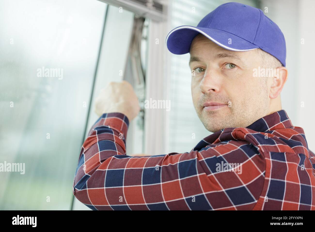 worker hands installing mosquito net Stock Photo