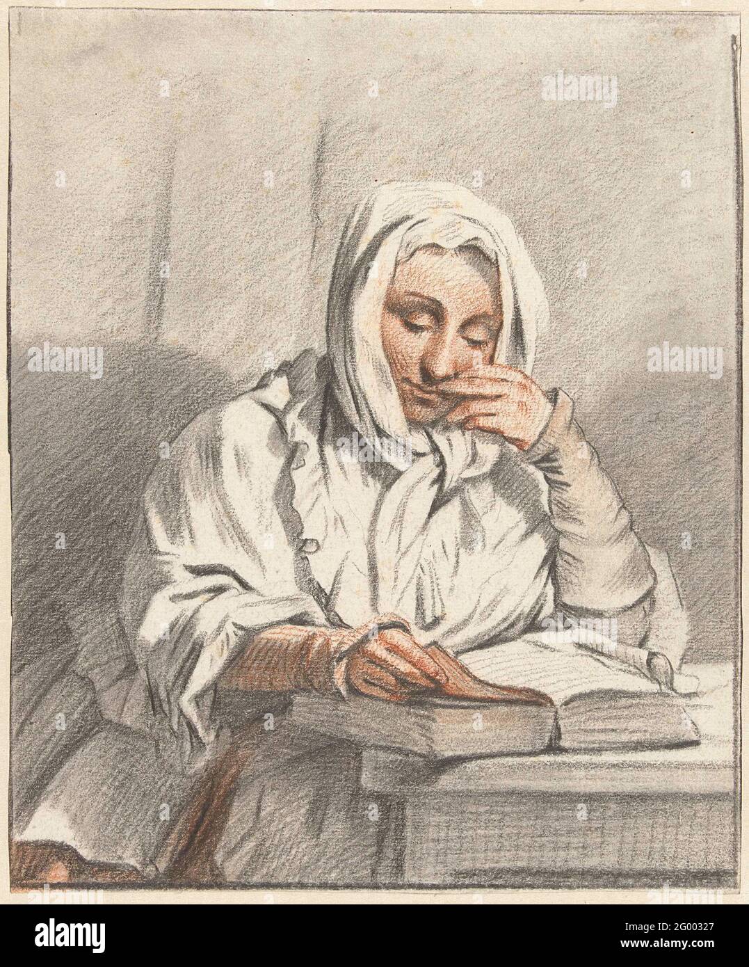 Reading young woman at a table Stock Photo - Alamy