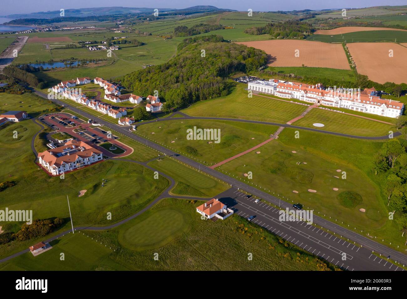 Turnberry, Scotland, UK. 30th May, 2021. PICTURED: Drone photography view of Trump Turnberry Golf Resort under the hot afternoon sunshine. Restrictions have lifted allowing the hotel to reopen back up allowing tourists to come in and play a round of golf. Former US President Donald Trump owed the hotel and golf resort, who passed to his son Eric Trump when his father took office in the White House. Pic Credit: Colin Fisher/Alamy Live News Stock Photo