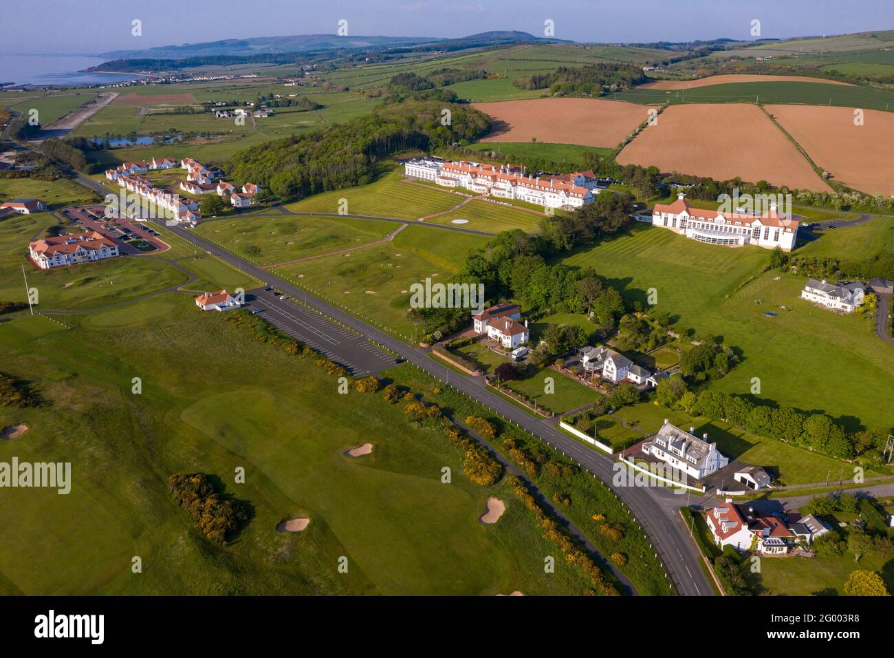 Turnberry, Scotland, UK. 30th May, 2021. PICTURED: Drone photography view of Trump Turnberry Golf Resort under the hot afternoon sunshine. Restrictions have lifted allowing the hotel to reopen back up allowing tourists to come in and play a round of golf. Former US President Donald Trump owed the hotel and golf resort, who passed to his son Eric Trump when his father took office in the White House. Pic Credit: Colin Fisher/Alamy Live News Stock Photo