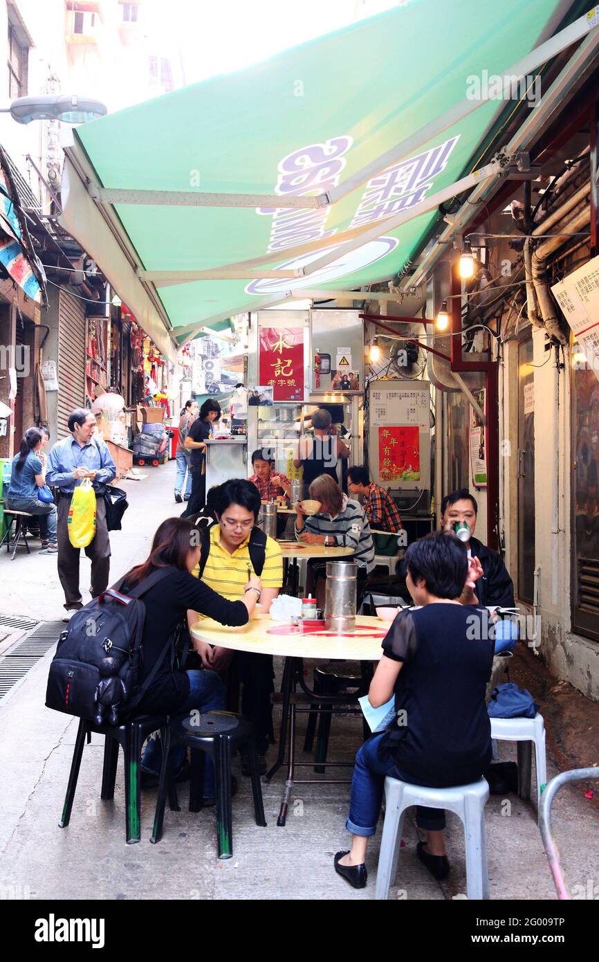 HONG KONG APR. 19, 2011 Lunch time crowd eat at openair street food